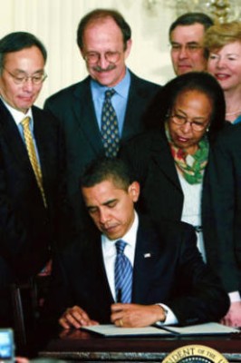 Memorial Sloan-Kettering President Harold Varmus (center, in blue shirt) joined Cabinet members, members of Congress, and other stem cell research advocates to witness President Barack Obama signing an Executive Order lifting the government's ban on federal funding for stem cell research at a White House ceremony on March 9.