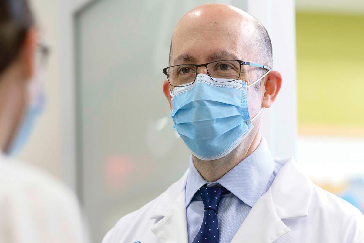 Medical oncologist Matthew Matasar is seen talking to a colleague
