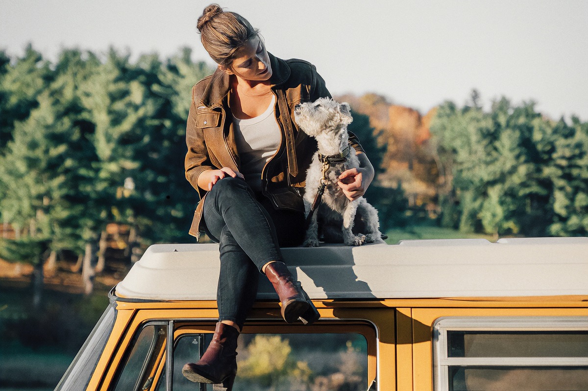 Suleika Jaouad with her dog on top of a van
