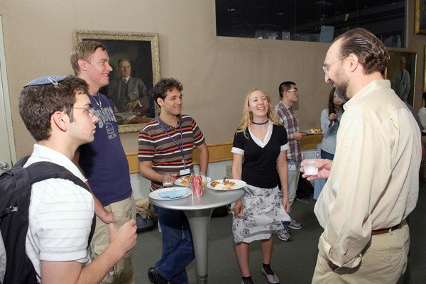 Dean Ken Marians greets incoming summer students -- Matthew Wieder, Artem Serganov, Adolfo Cuesta, and Dierdre Kelly -- at a June 1 reception held to welcome summer students to the Gerstner Sloan Kettering community.
