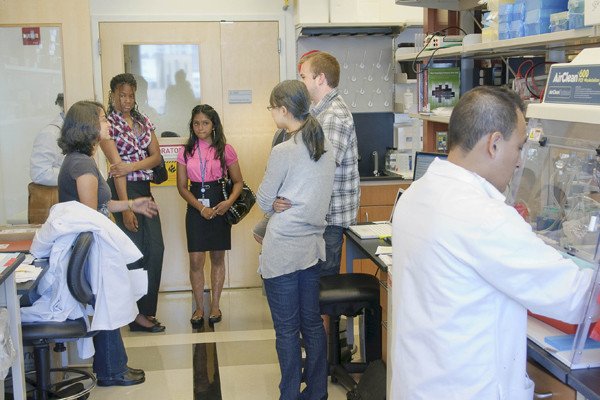 Third-Year PhD student Semanti Mukherjee (left) explains the work of the Robert Klein Lab to future scientists participating in Summer Exposure Program for high school students.