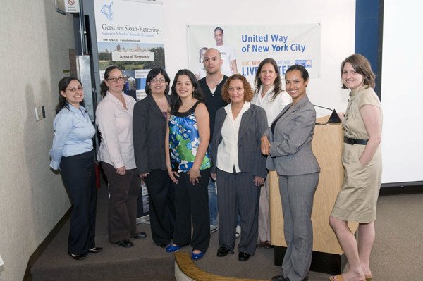 Program supporters included Gerstner Sloan Kettering PhD student Eric Alonzo (center) and Associate Dean C. Gita Bosch (center, gray suit and white blouse), as well as staff from Focus Forward, United Way of New York City, and the New York City Board of Education.