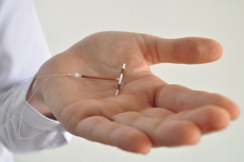 Man holding an IUD