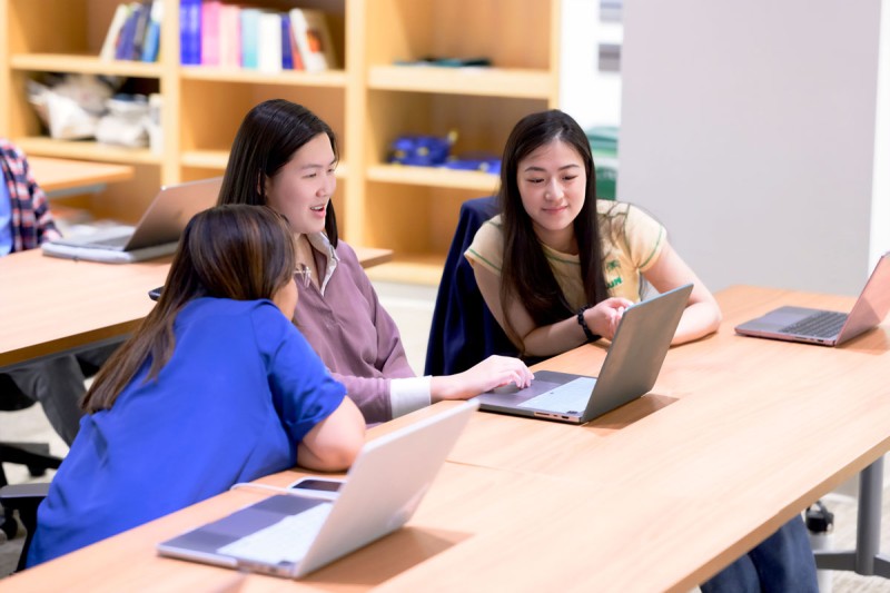 Three GSK students in a classroom