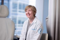 Dr. Eileen O'Reilly seen smiling in an exam room. 