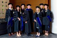 GSK dean and graduates in their caps and gowns