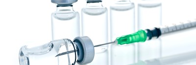 Needle entering a vaccine vial. 