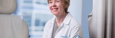 Dr. Eileen O'Reilly seen smiling in an exam room.